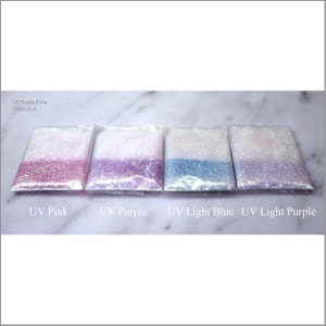 May include: Four small bags of UV Extra Fine glitter in the colors pink, purple, light blue, and light purple. The bags are labeled with the color name.