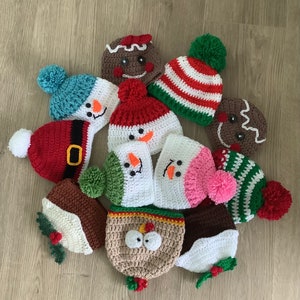 May include: A collection of ten handmade crocheted Christmas hats in various colors and designs, including a snowman, gingerbread man, and a candy cane.