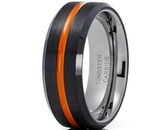 May include: A black tungsten carbide ring with an orange stripe. The ring is engraved with "TUNGSTEN CARBIDE".