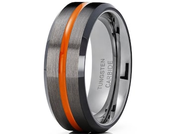 May include: A black tungsten carbide ring with an orange stripe down the center. The ring is engraved with "TUNGSTEN CARBIDE".