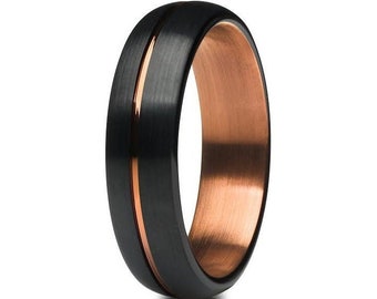 May include: A black tungsten carbide ring with a rose gold inlay. The ring has a brushed finish and a beveled edge.
