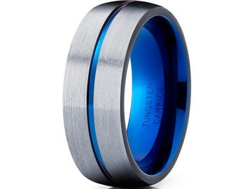 May include: A silver tungsten carbide ring with a blue inlay and a brushed finish. The ring has the words "TUNGSTEN CARBIDE" engraved on the inside.