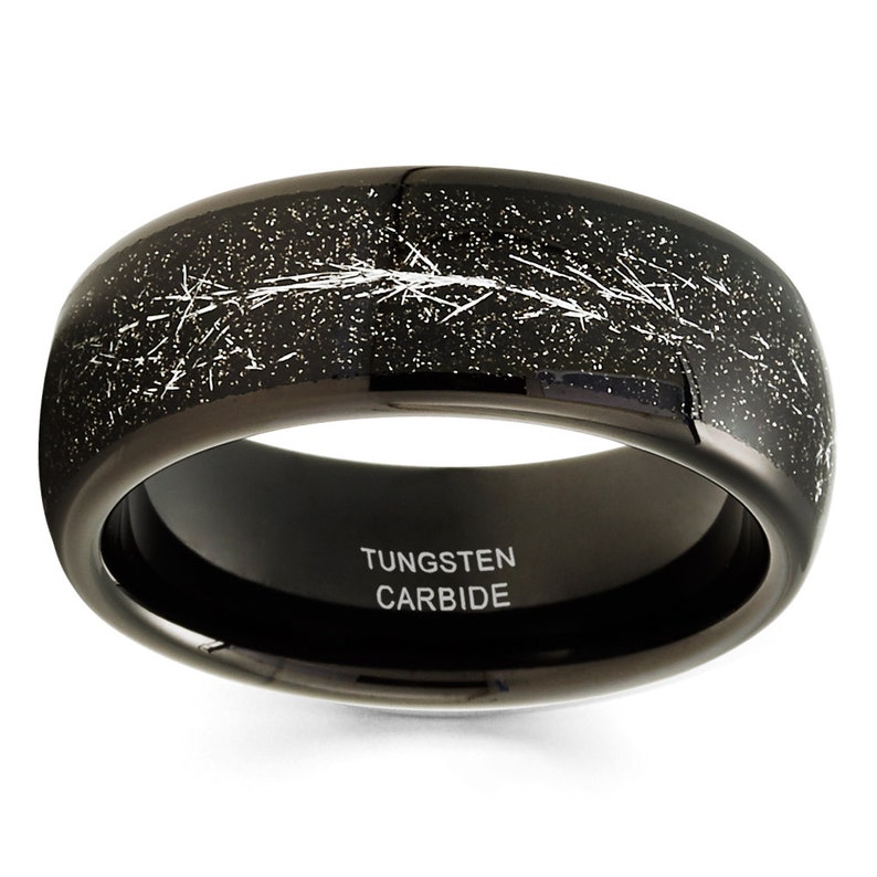 May include: Black tungsten carbide ring with a distressed finish and white lines. The inside of the band is engraved with "TUNGSTEN CARBIDE".