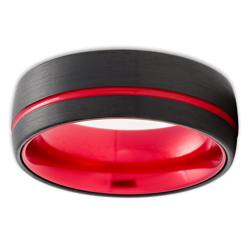 May include: A black tungsten carbide ring with a red inner band and a red line around the outer edge.
