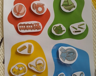 May include: A children's educational game with the text "Place les objets dans la bonne couleur." The game features colorful shapes with illustrations of a ball, train, boat, teapot, car, and other objects.