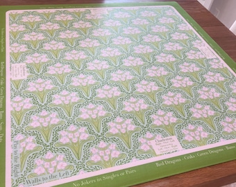 May include: A green and pink patterned game board with text. The board features a repeating floral design in pink and green on a light green background. The border is green, and the text includes "Walls to the Left" and "Play to the Right."