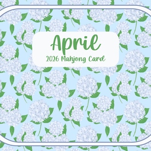 May include: A light blue 2026 Mahjong card with a floral pattern of white hydrangea flowers and green leaves. The card has a white border and a central rectangle with the word "April" in green script.