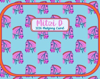 May include: A light blue background features a pattern of pink horse heads with blue bridles. The image is framed with an orange border. A white rectangle in the center reads "Mitzi D 2026 Mahjong Card".