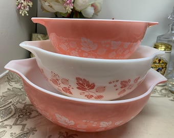 May include: Set of three pink and white mixing bowls with a gooseberry pattern. The bowls are nested inside each other.