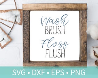 May include: A wooden sign with the text "Wash Brush Floss Flush" in a white frame. The sign is on a white brick background with cotton bolls on the right side.