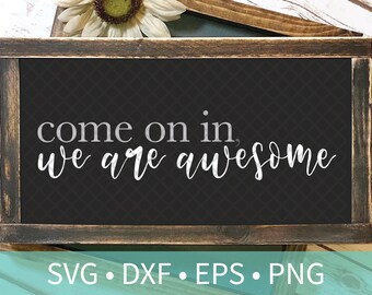 May include: A black framed sign with a white background and the text "come on in, we are awesome" in a white cursive font.