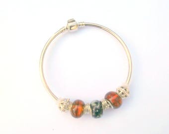 Semi open and bronzed pearl bracelet