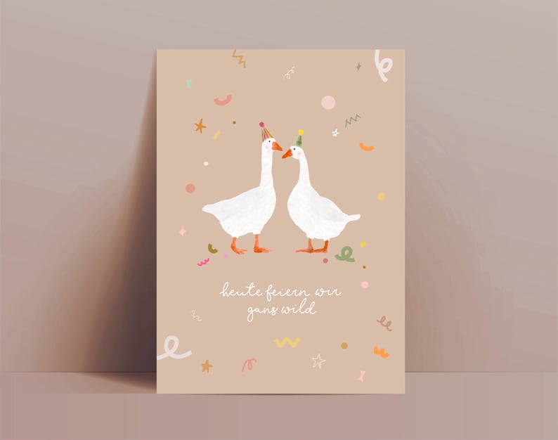 May include: A greeting card featuring two white geese wearing party hats, set against a beige background with confetti and the text "heute feiern wir ganz wild". The geese have orange feet and beaks. The card is rectangular.