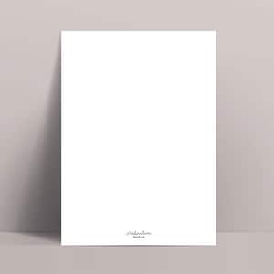 May include: A white rectangular print leaning against a light gray wall. The print has a small, handwritten signature in black ink in the lower right corner. The print is displayed on a light gray surface.