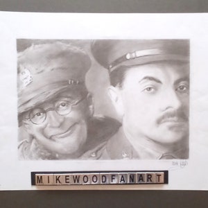 May include: A black and white pencil drawing of two men in military uniforms. The man on the left is smiling and wearing glasses. The man on the right has a serious expression. The drawing is signed "Mike Wood Fan Art".