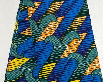 May include: Folded fabric with a vibrant pattern. The design features blue, yellow, orange, and green wavy lines and shapes. The fabric has a white border with the text "HITARGET".