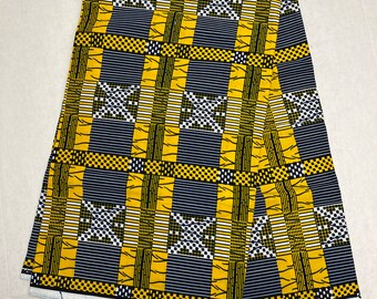 May include: Folded fabric with a striking geometric design. The pattern incorporates yellow, black, and white squares and rectangles in a grid-like arrangement. The fabric's repeating pattern is suitable for clothing or home decor.