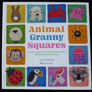 Puede incluir: Una portada de libro con el título "Animal Granny Squares" y una ilustración colorida de 12 cuadrados de animales tejidos a crochet. La portada del libro presenta el texto "40 bloques de crochet lindos para hacer decoraciones, artículos para el hogar, mantas y más." y el nombre del autor "Leonie Morgan".
