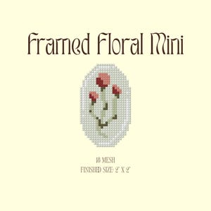 Puede incluir: Un diseño de mini punto de cruz floral enmarcado con tres flores rojas con tallos y hojas verdes. El diseño tiene forma ovalada y está rodeado por un fondo blanco. El texto "framed Floral Mini" está en la parte superior, y "18 mesh" y "finished size: 5 cm x 5 cm" están en la parte inferior.