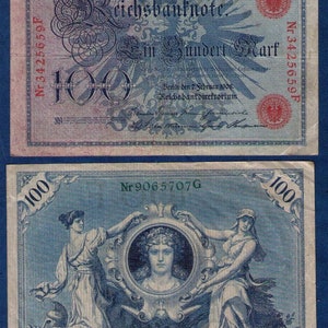May include: A blue and white German banknote with the text "Reichsbanknote" and "Ein Hundert Mark". The banknote features a portrait of a woman and the number "100" in large font.