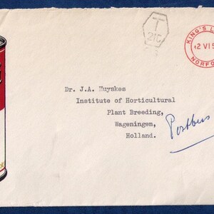 May include: A red and white can of Campbell's Condensed Tomato Soup. The can has a gold label with the text "Campbell's Condensed Tomato Soup". The can is on a white envelope with a red stamp that says "King's Lynn Norfolk" and "=0/3". The envelope is addressed to Dr. J.A. Huynken, Institute of Horticultural Plant Breeding, Wageningen, Holland.