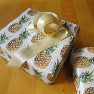 Luscious pineapples on a cream background make this giftwrap extra special.