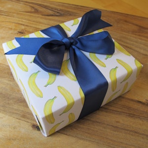 gorgeous banana giftwrap with blue ribbon