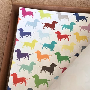 brightly-colored dachshunds make a whimsical pattern dancing upon a sheet of high-quality giftwrap.