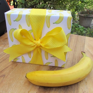 Banana giftwrap on gift with real banana for size