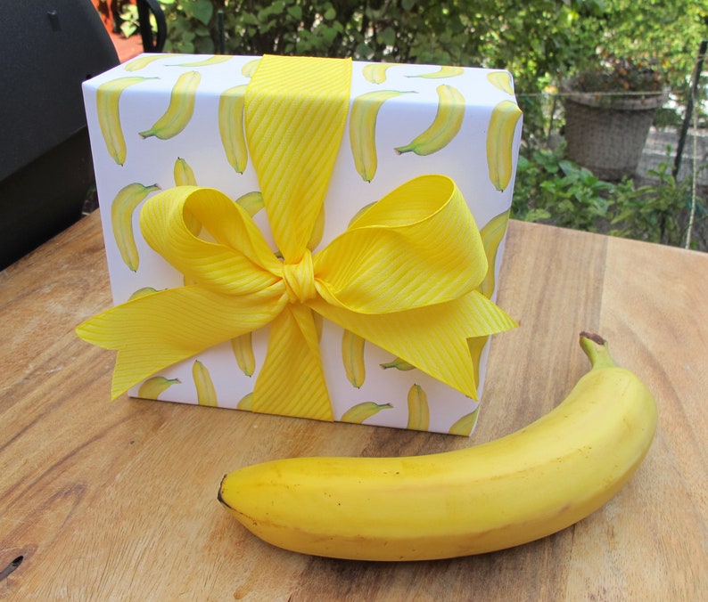 Banana giftwrap on gift with real banana for size