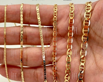May include: Six gold mariner chain necklaces of different widths, ranging from 1.2mm to 5mm, are displayed on a hand. The chains are all made of solid gold and have a polished finish.