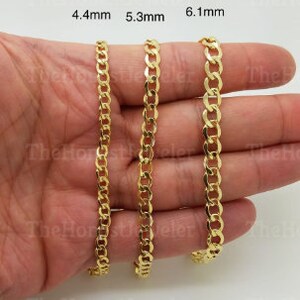 May include: Three gold chains of different widths, 4.4mm, 5.3mm, and 6.1mm, are displayed on a hand.