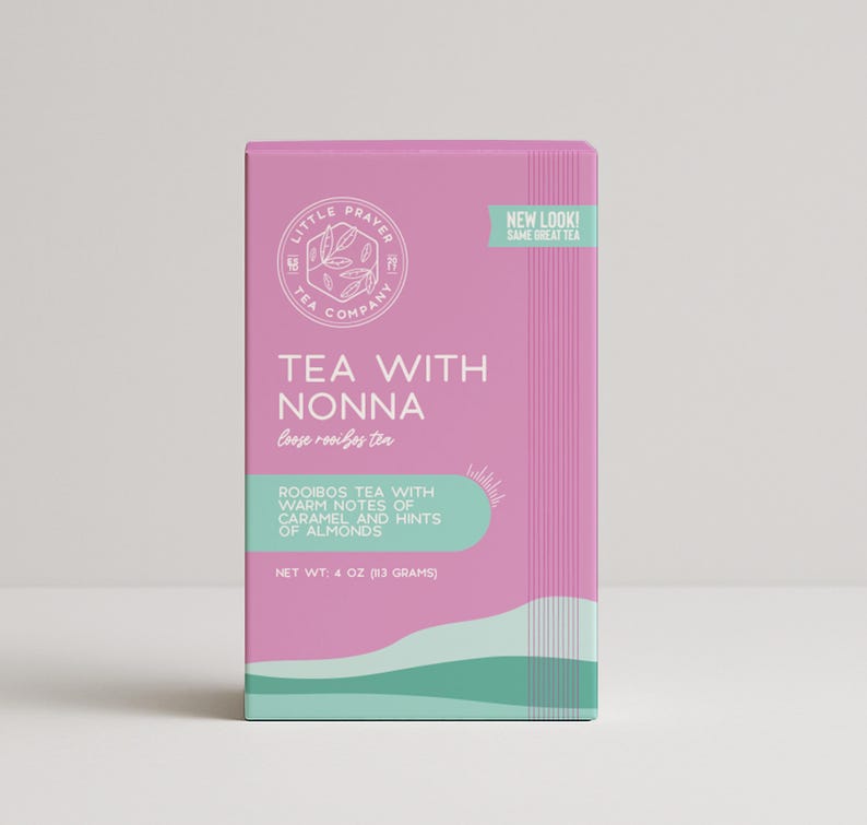 May include: Pink box with a teal and white design. The box contains loose rooibos tea called "Tea with Nonna". The text on the box reads "Rooibos tea with warm notes of caramel and hints of almonds". The net weight is 113 grams.