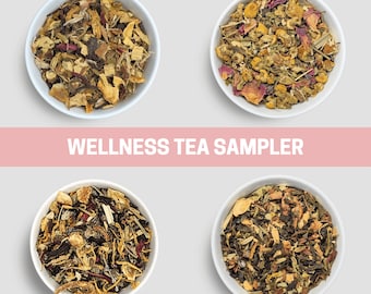 May include: Four white bowls filled with different types of wellness tea blends. The bowls are arranged in a square pattern on a white background. The text "WELLNESS TEA SAMPLER" is displayed in a pink banner above the bowls.