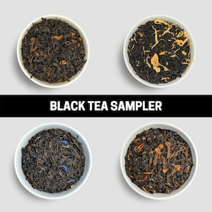 May include: Four white bowls filled with different varieties of black tea are displayed against a light gray background. The tea leaves vary in color and texture, with some containing visible spices and flower petals. The text "BLACK TEA SAMPLER" is in a black rectangle.