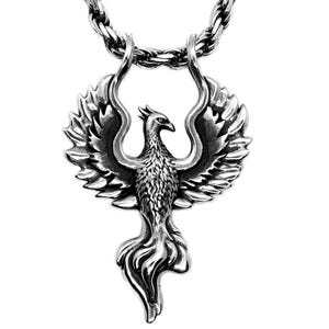 May include: A silver-colored pendant necklace featuring a detailed phoenix design. The phoenix has outstretched wings and a flowing tail, suspended from a thick, textured chain. The pendant is approximately 2 inches in height.