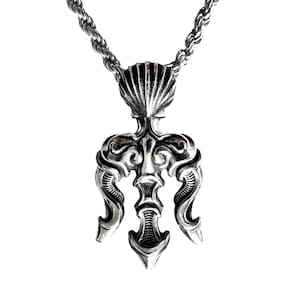 May include: A silver pendant necklace featuring a detailed trident design with a seashell at the top. The pendant is attached to a silver rope chain.