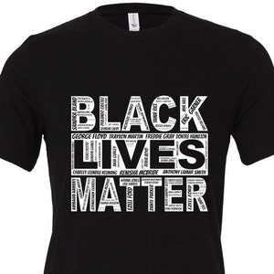 May include: Black Lives Matter t-shirt with a white graphic design featuring the words "Black Lives Matter" in large letters. The graphic also includes the names of many people who have been killed by police brutality.