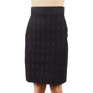 May include: A black skirt with a geometric pattern. The skirt is made of a lightweight, breathable fabric and has a fitted silhouette.