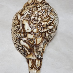 Handcarved Conch Shell Vajrapani / Chakna Dorje is a fierce protector deity. 100 % Handmade from Nepal