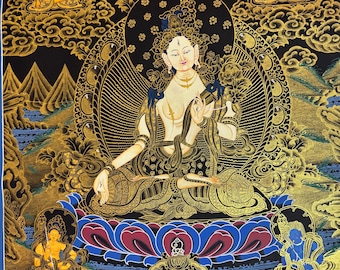 May include: A traditional Tibetan Buddhist thangka painting depicting a deity in a seated position with a golden halo. The deity is surrounded by other figures and symbols, including a lotus flower and clouds. The painting is done in a vibrant palette of colors, including gold, red, blue, and green.