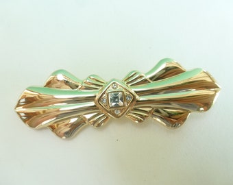 Vintage brooch from before 2000, retro Art Deco, metal and glass, golden and transparent colors.