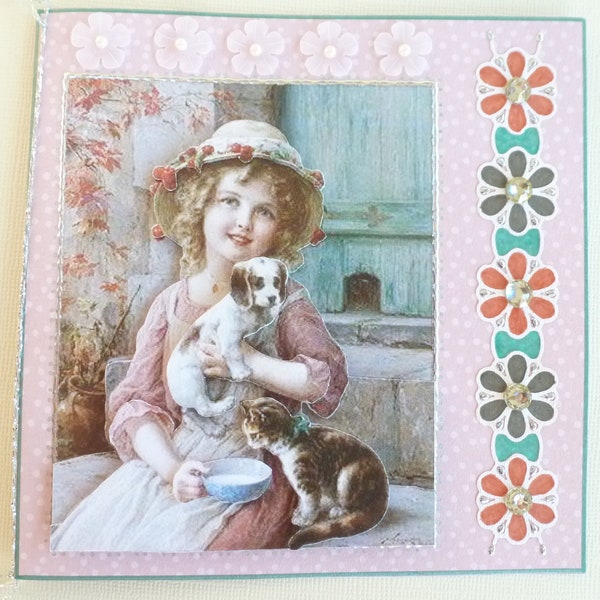 Carte de voeux personnalisable "Petite fille, chat et chien" en 3D, papier et plastique, coloris rose, bleu, marron et blanc.