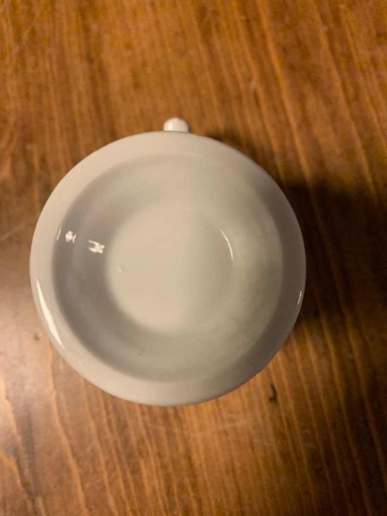 May include: White ceramic mug with a smooth, rounded interior. The mug is empty and appears to be new.