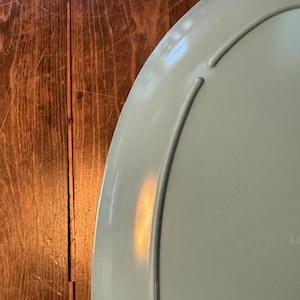 May include: A light blue oval serving platter with a slightly raised rim.