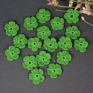 May include: A collection of 16 green crocheted flower embellishments, perfect for adding a touch of handmade charm to crafts and projects.