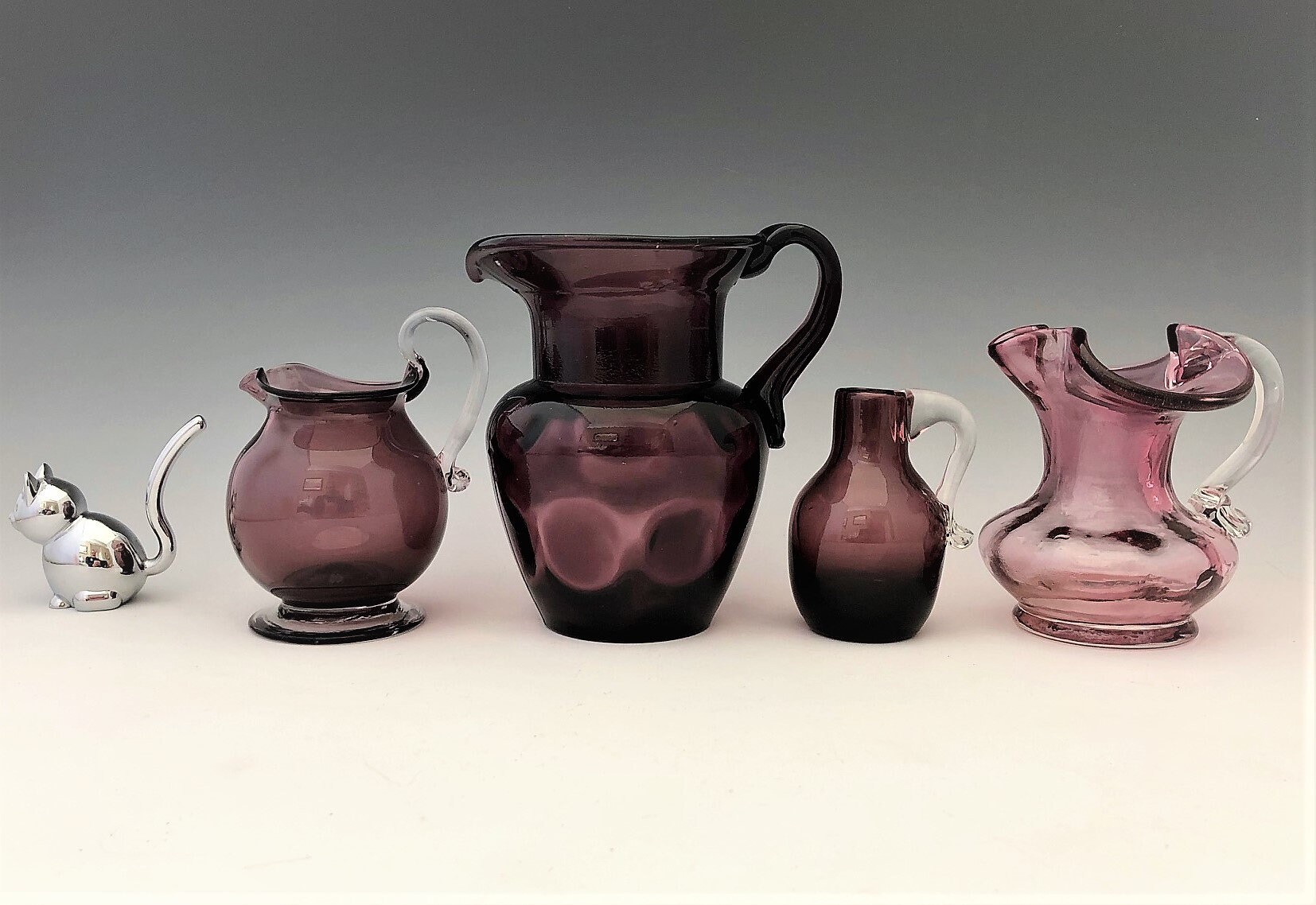 Collection of 4 Purple Art Glass Pitchers Kanawha/Pilgrim/Rainbow