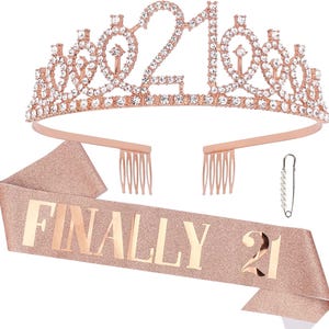 May include: Rose gold tiara with rhinestones and the number 21, a rose gold sash with glitter and the text "FINALLY 21".