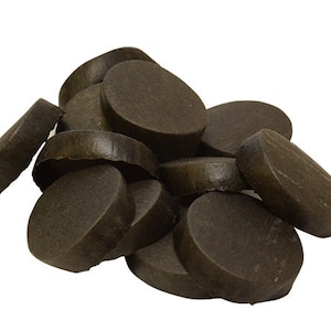 May include: A pile of dark brown round wooden discs. The discs are smooth and have a slightly textured surface.