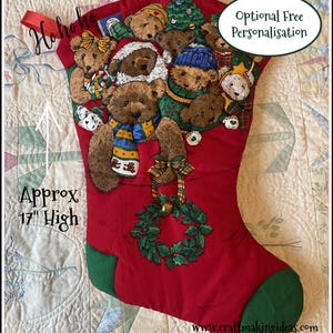 May include: A red Christmas stocking with a green heel and toe, adorned with teddy bears in festive outfits. The stocking is approximately 43 cm high and features a green wreath with a gold bell.